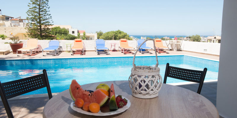 Poolside seating with fruit at Houmeli Apartments, Kalamaki Crete.