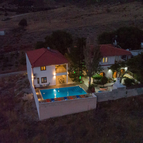 Aerial night view of Houmeli Apartments in Kalamaki Crete, with the pool and courtyard softly lit