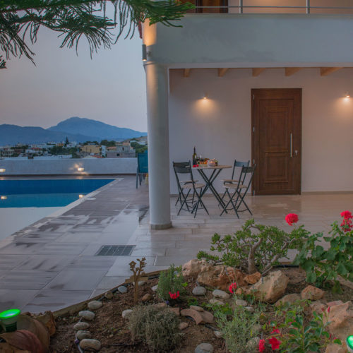 Evening terrace beside a pool with mountain views at Houmeli Apartments in Kalamaki, Crete