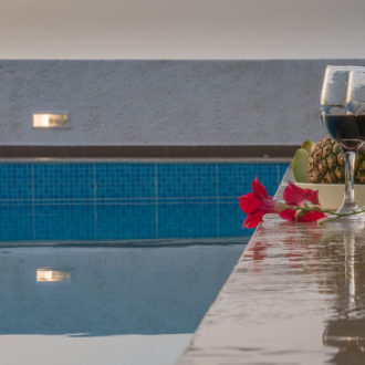 Wine and fruit by the pool at Houmeli Apartments, Kalamaki Crete.