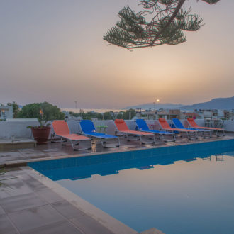 Sunset view over the pool area at Houmeli Apartments in Kalamaki, Crete.b