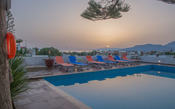 Sunset view over the pool area at Houmeli Apartments in Kalamaki, Crete.b