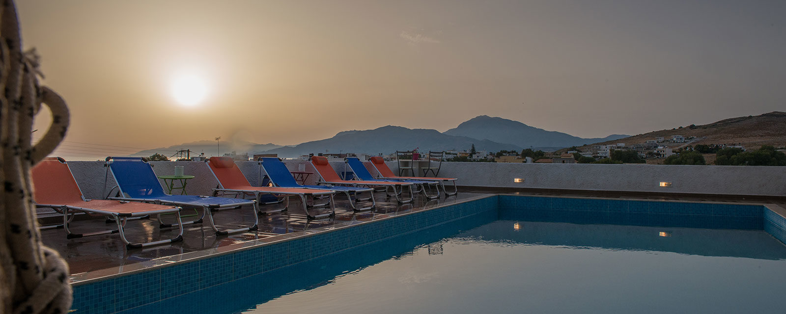 Sunset by the pool at Houmeli Apartments in Kalamaki, Crete.
